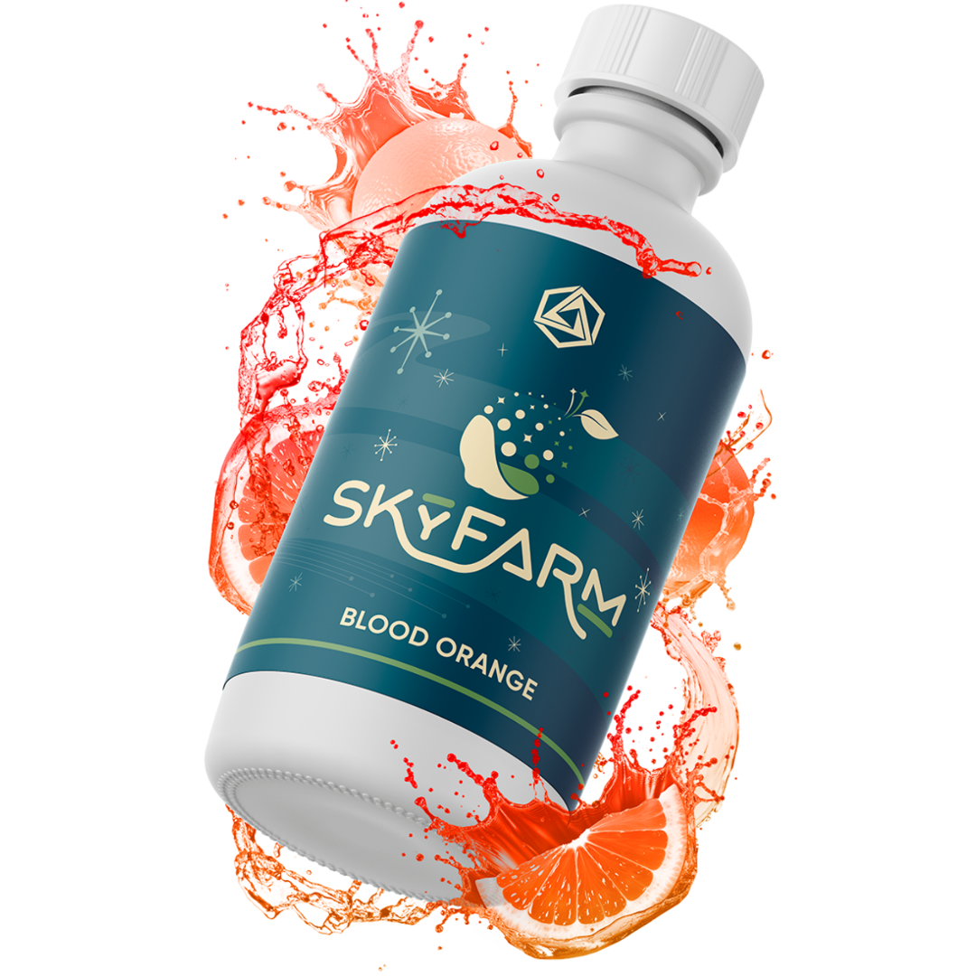 Bottle of SkyFarm Blood Orange juice with an orange splash on a white background